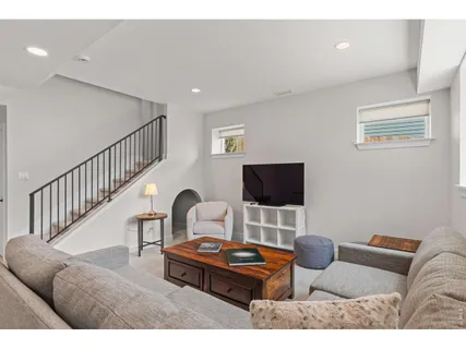 a living room with furniture and a dining table