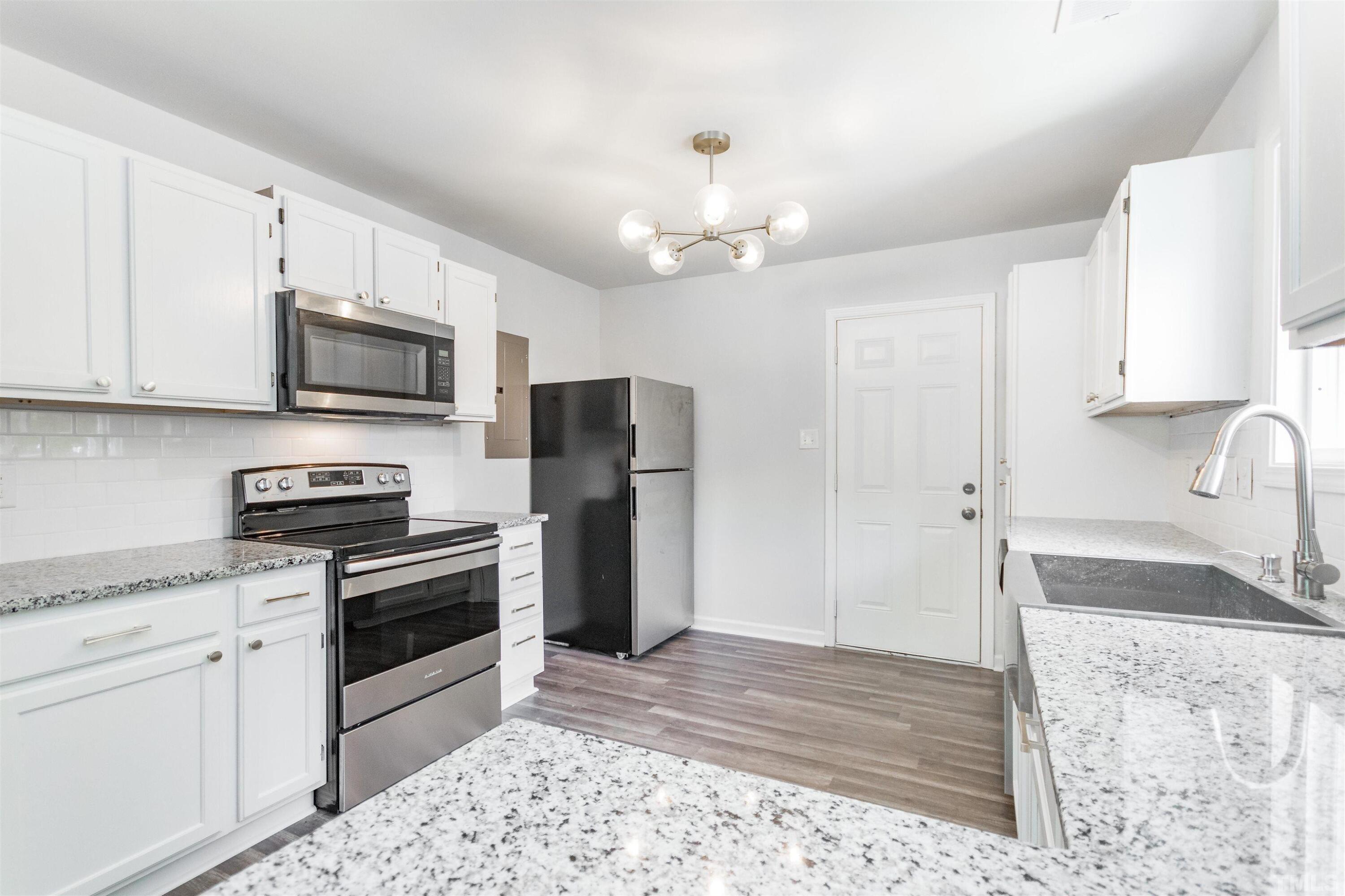 708 Bailey Drive Raleigh, NC 27610 - Photo 5 of 10 a kitchen with stainless steel appliances granite countertop a stove a refrigerator and a sink