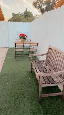 a view of a chairs and table in patio