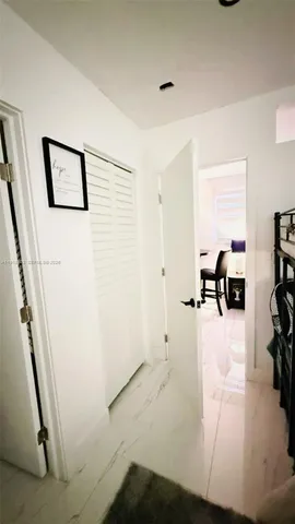 a view of a livingroom with furniture and hardwood floor