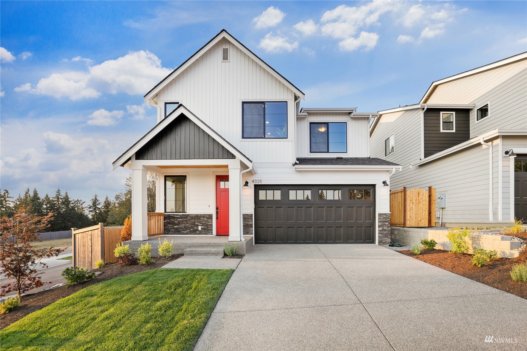 4325 244th Street Southeast, Unit LOT36 Bothell, WA 98021 - Photo 1 of 38 a front view of a house with a yard and garage