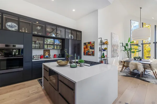 a kitchen with stainless steel appliances granite countertop a sink and a refrigerator