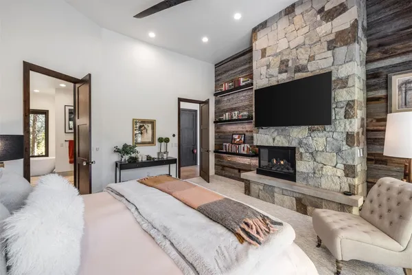 a bedroom with a bed and a fireplace