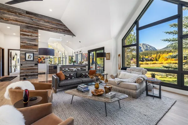a living room with fireplace furniture and a large window