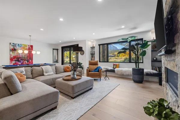 a living room with furniture and a wooden floor