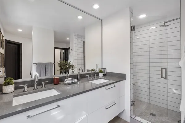 a bedroom with a bed and glass walk in closet