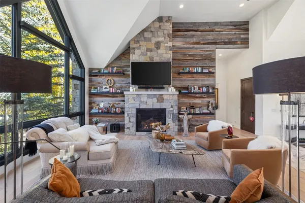a living room with furniture a flat screen tv and a fireplace