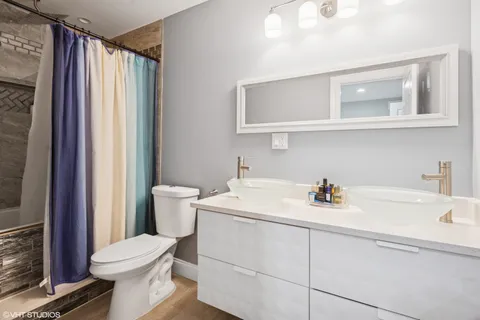 a bathroom with a sink toilet and shower