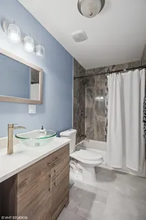a bathroom with a sink toilet and shower