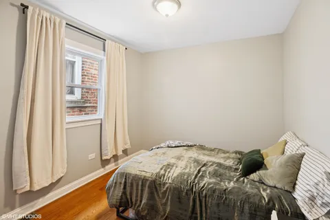 a bed sitting in a bedroom next to a window