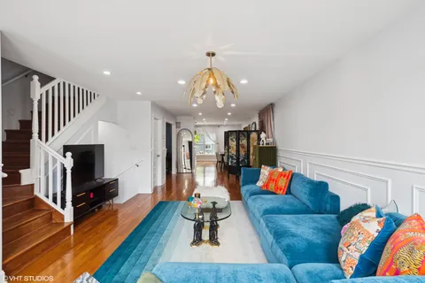 a living room with furniture fireplace and wooden floor