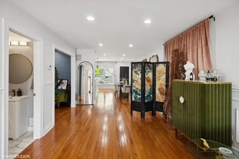 a view of a living room with furniture and wooden floor