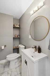 a bathroom with a sink a toilet and a mirror
