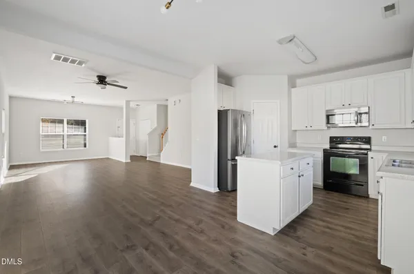 a kitchen with stainless steel appliances a refrigerator stove microwave and cabinets