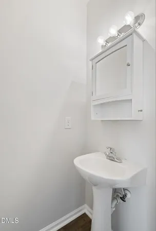 a bathroom with a sink a mirror and vanity