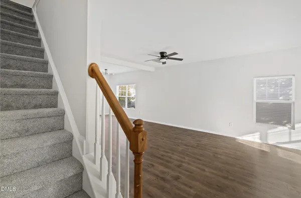 a view of entryway and hall with wooden floor