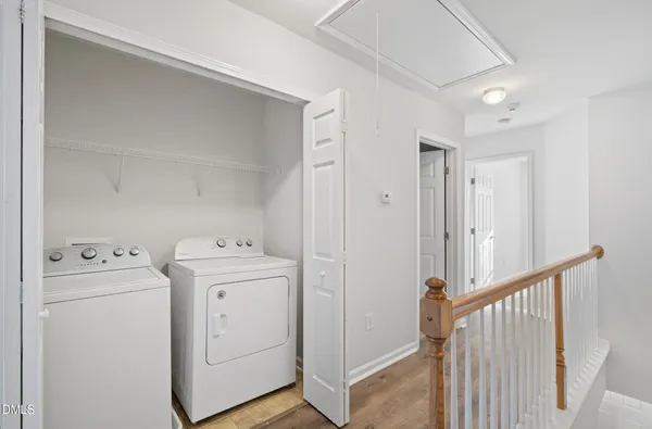 a view of a storage & utility room with dryer and washer