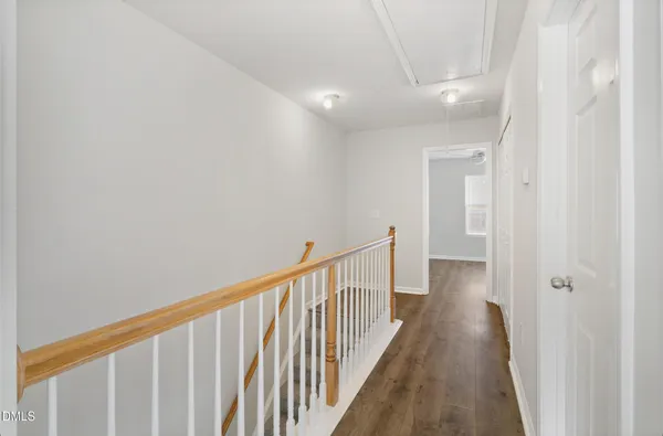 a view of a hallway with wooden floor