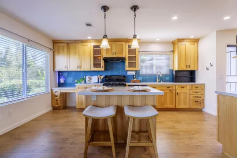a kitchen with stainless steel appliances kitchen island granite countertop a sink and cabinets