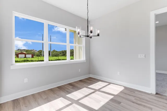 a kitchen with kitchen island a sink stainless steel appliances and wooden floor