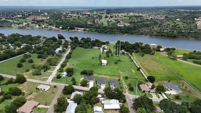 an aerial view of lake residential houses with outdoor space and trees