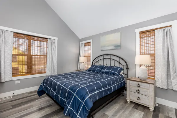 a bedroom with a bed and a large window