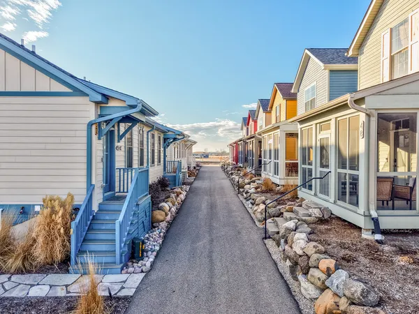 a view of a terrace with lawn chairs