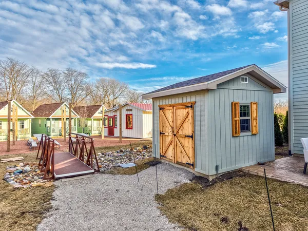 a view of a house with pool and chairs