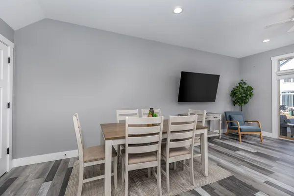 a living room with furniture a flat screen tv and a floor to ceiling window
