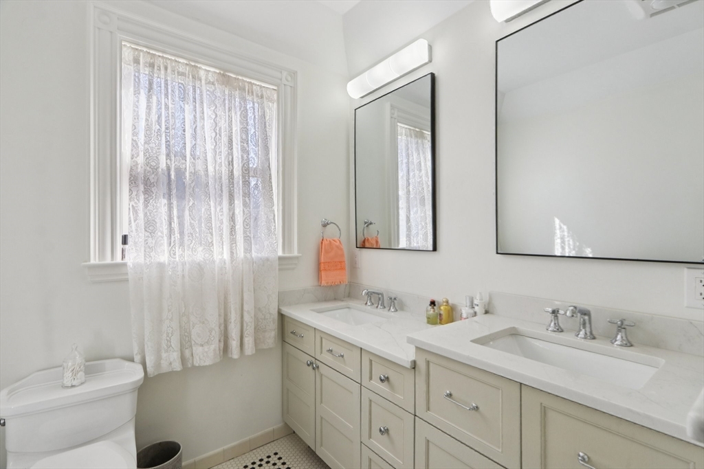 35 Frances Street Melrose, MA 02176 - Photo 17 of 42 a bathroom with a granite countertop sink and a mirror