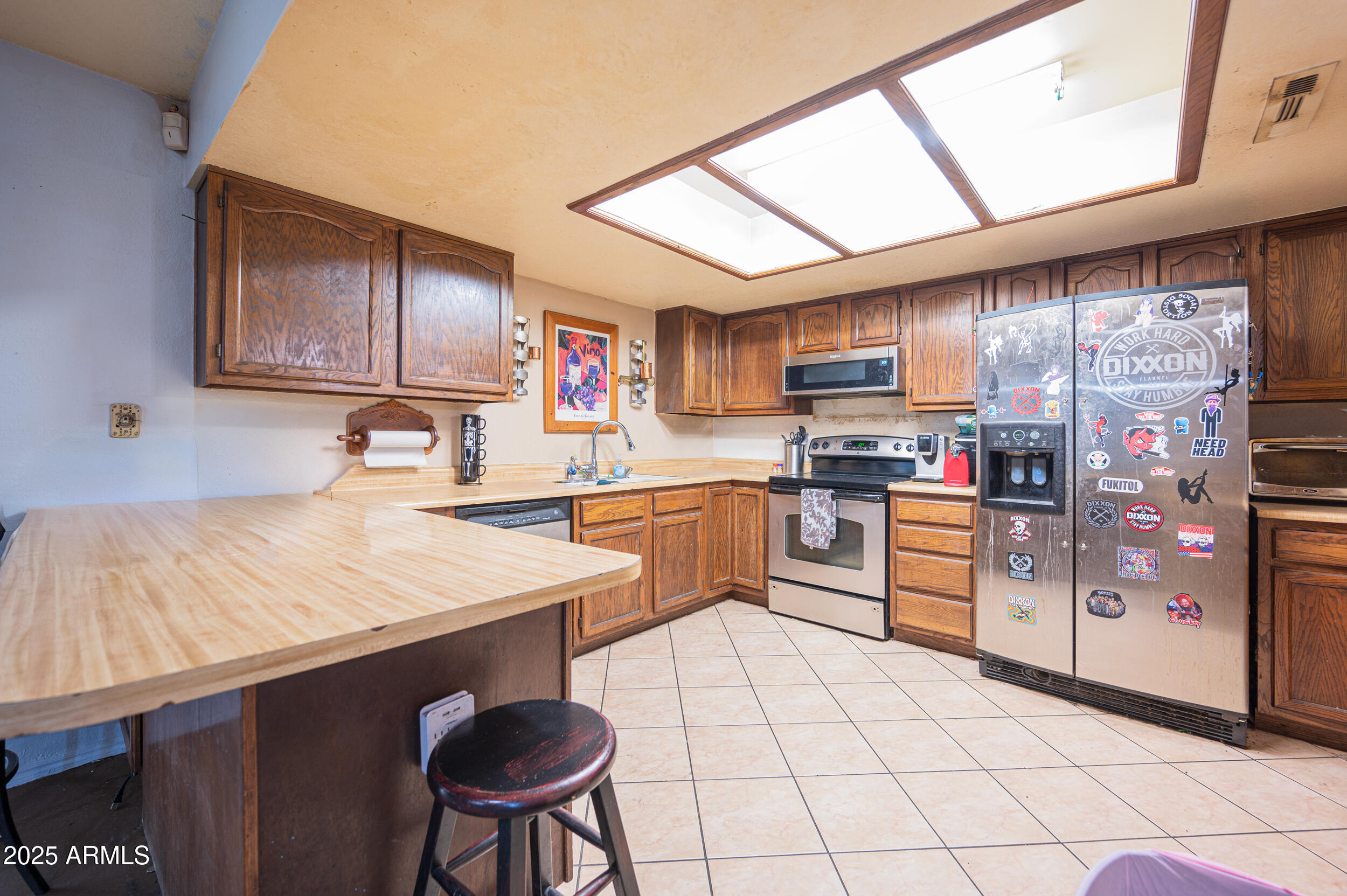 662 South Seton Mesa, AZ 85206 - Photo 13 of 25 a kitchen with stainless steel appliances granite countertop a sink a stove a refrigerator cabinets and a dining table