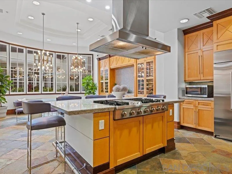 9237 Regents Road, Unit K101 La Jolla, CA 92037 - Photo 26 of 29 a kitchen with stainless steel appliances granite countertop a stove a sink and a refrigerator