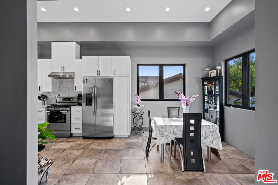 6006 Spring Valley Road Hidden Hills, CA 91302 - Photo 23 of 31 a kitchen with refrigerator and cabinets