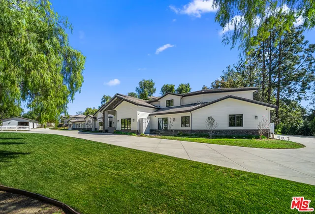 a living room with furniture a flat screen tv and a large window