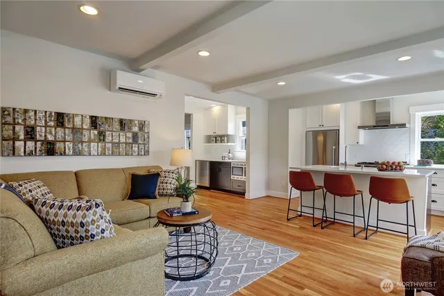 a kitchen with stainless steel appliances a refrigerator a stove a dining table and chairs