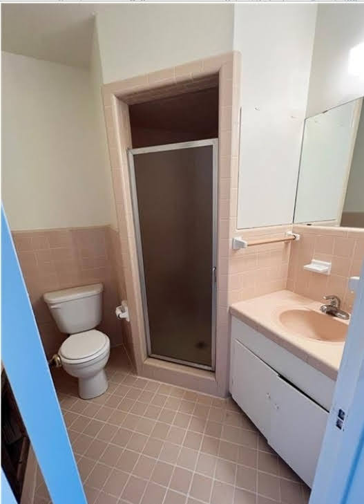809 North 8th Street Temple, TX 76501 - Photo 10 of 20 A well-maintained bathroom with a convenient shower and a classic tile floor.