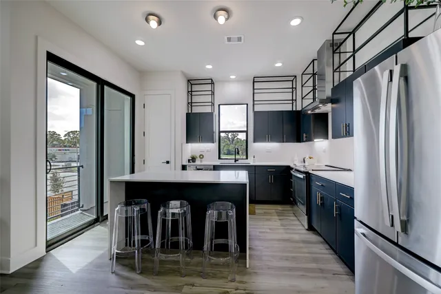a kitchen with kitchen island a counter appliances a sink and cabinets