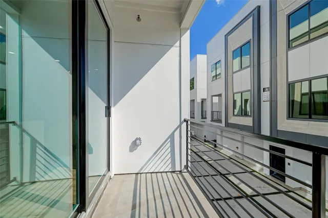 a bedroom with a bed a chair and a potted plant