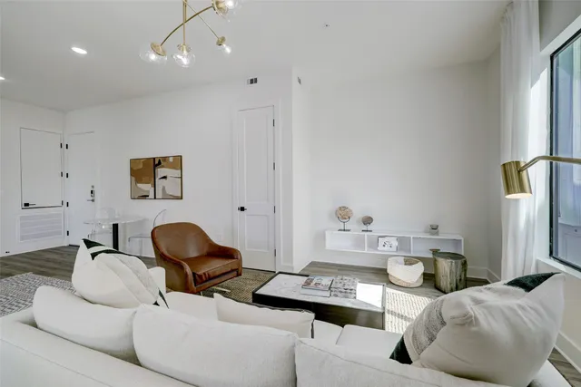 a large bedroom with a large bed and a chandelier