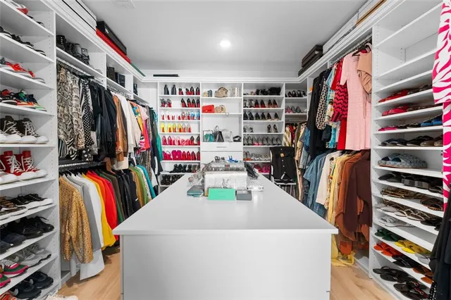 a spacious bedroom with a bed and a cabinets