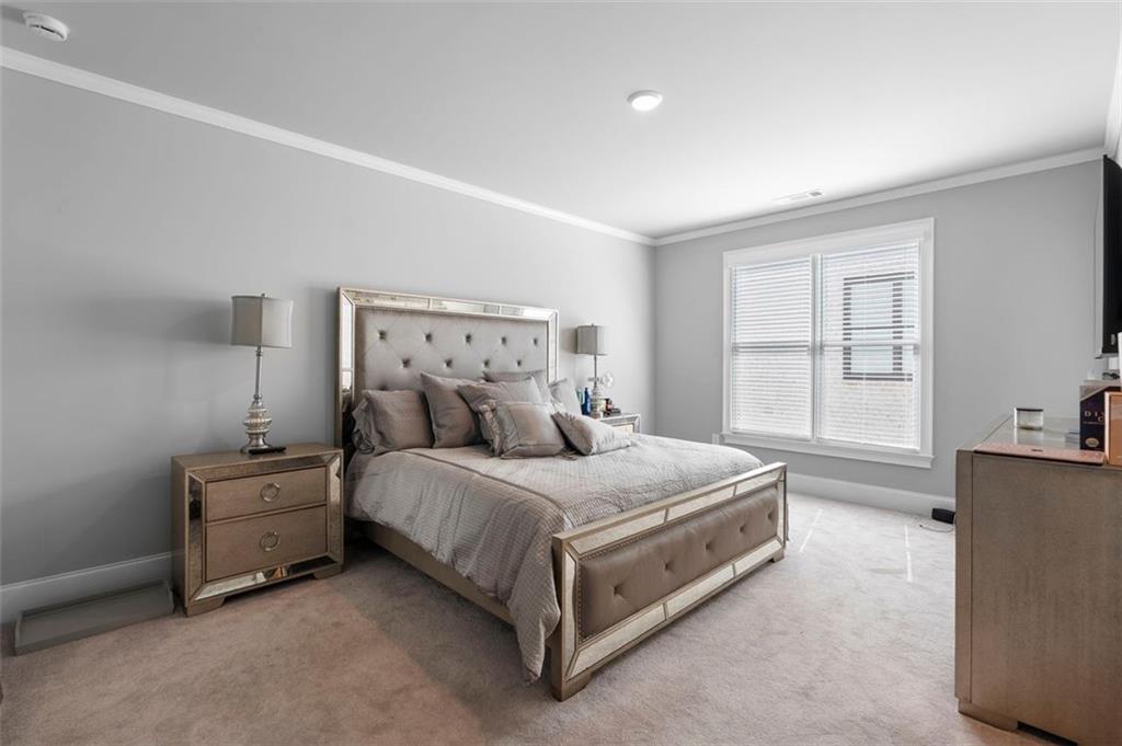 4097 Gilmore Road Southeast Smyrna, GA 30080 - Photo 16 of 26 a spacious bedroom with a bed and a cabinets