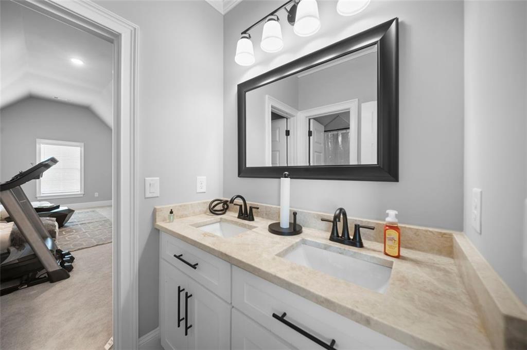 4097 Gilmore Road Southeast Smyrna, GA 30080 - Photo 17 of 26 a bathroom with mirror a sink and vanity