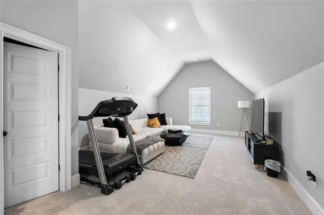 a spacious bedroom with a bed and a chandelier