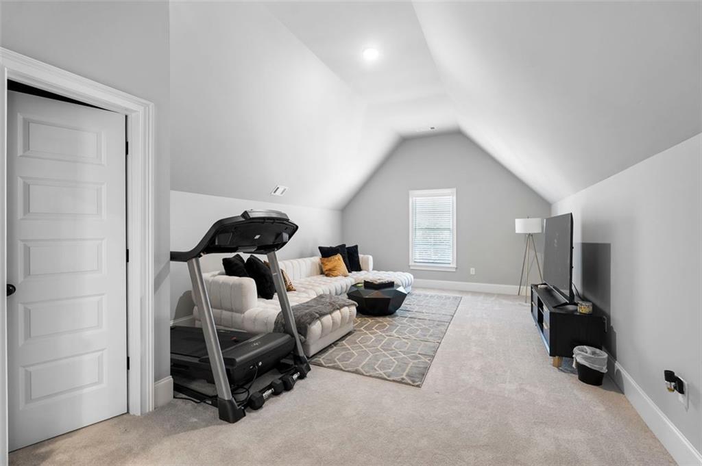 4097 Gilmore Road Southeast Smyrna, GA 30080 - Photo 18 of 26 a living room with furniture and a gym machine next to a window