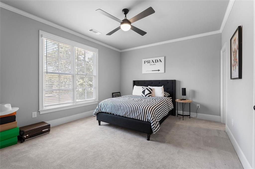 4097 Gilmore Road Southeast Smyrna, GA 30080 - Photo 19 of 26 a spacious bedroom with a bed and a chandelier