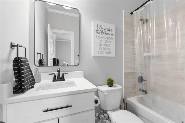 a room with furniture a flat screen tv and a window