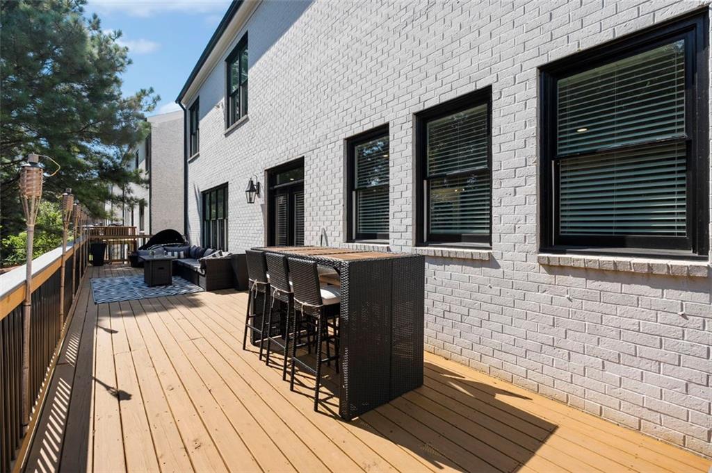 4097 Gilmore Road Southeast Smyrna, GA 30080 - Photo 24 of 26 a view of a patio with table and chairs wooden floor and fence