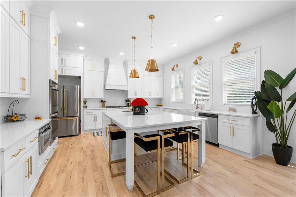 4097 Gilmore Road Southeast Smyrna, GA 30080 - Photo 5 of 26 a kitchen with stainless steel appliances granite countertop a stove a refrigerator a oven a sink with island and chairs