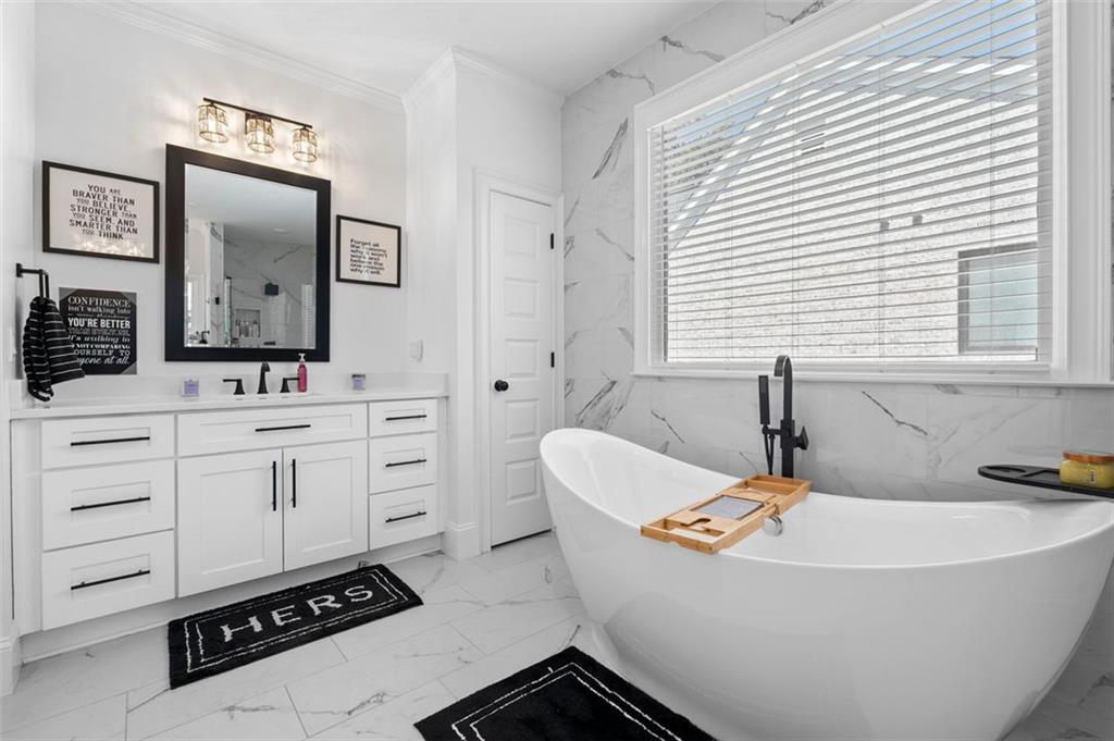4097 Gilmore Road Southeast Smyrna, GA 30080 - Photo 10 of 26 a bathroom with a bathtub sink and a mirror