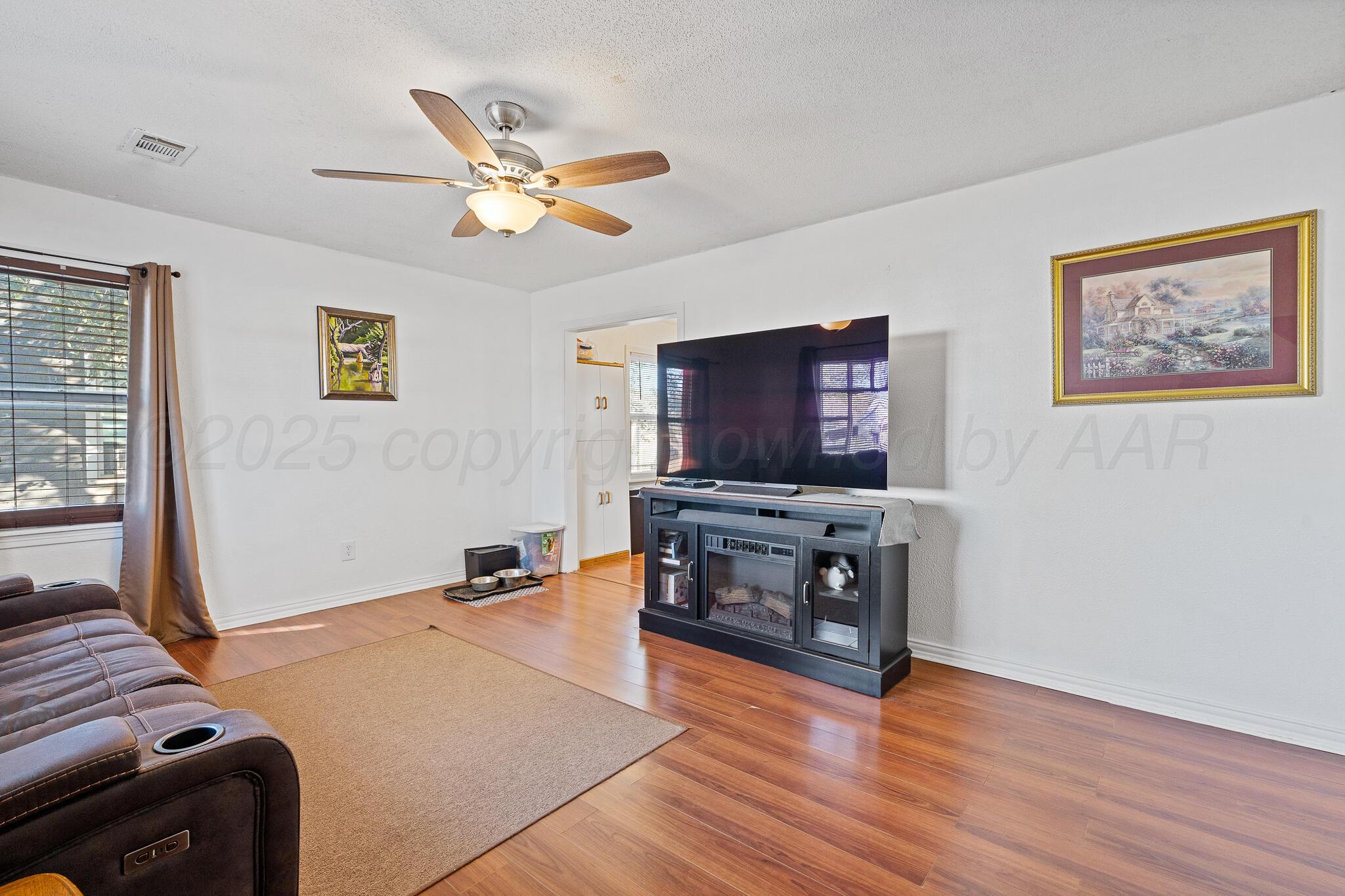 4105 Parker Street Amarillo, TX 79110 - Photo 3 of 10 a living room with furniture and a flat screen tv